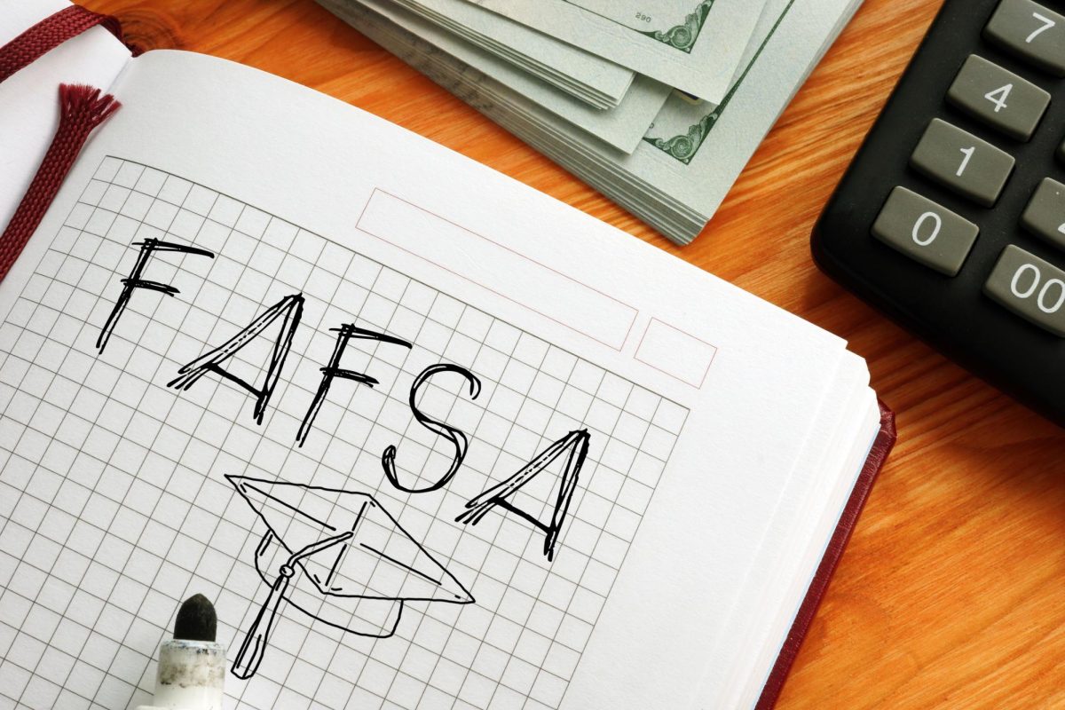 A college notebook with the word FAFSA with a graduation cap written inside. The U.S. Department of Education announced new regulations to make financial aid more accessible to students. (Courtesy of Getty Images)