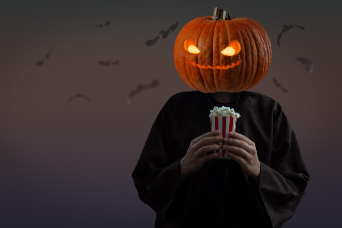 A+man+with+a+pumpkin+head+holds+a+carton+of+popcorn.+Whats+your+favorite+Halloween+movie%3F+%28Courtesy+of+Getty+Images%29