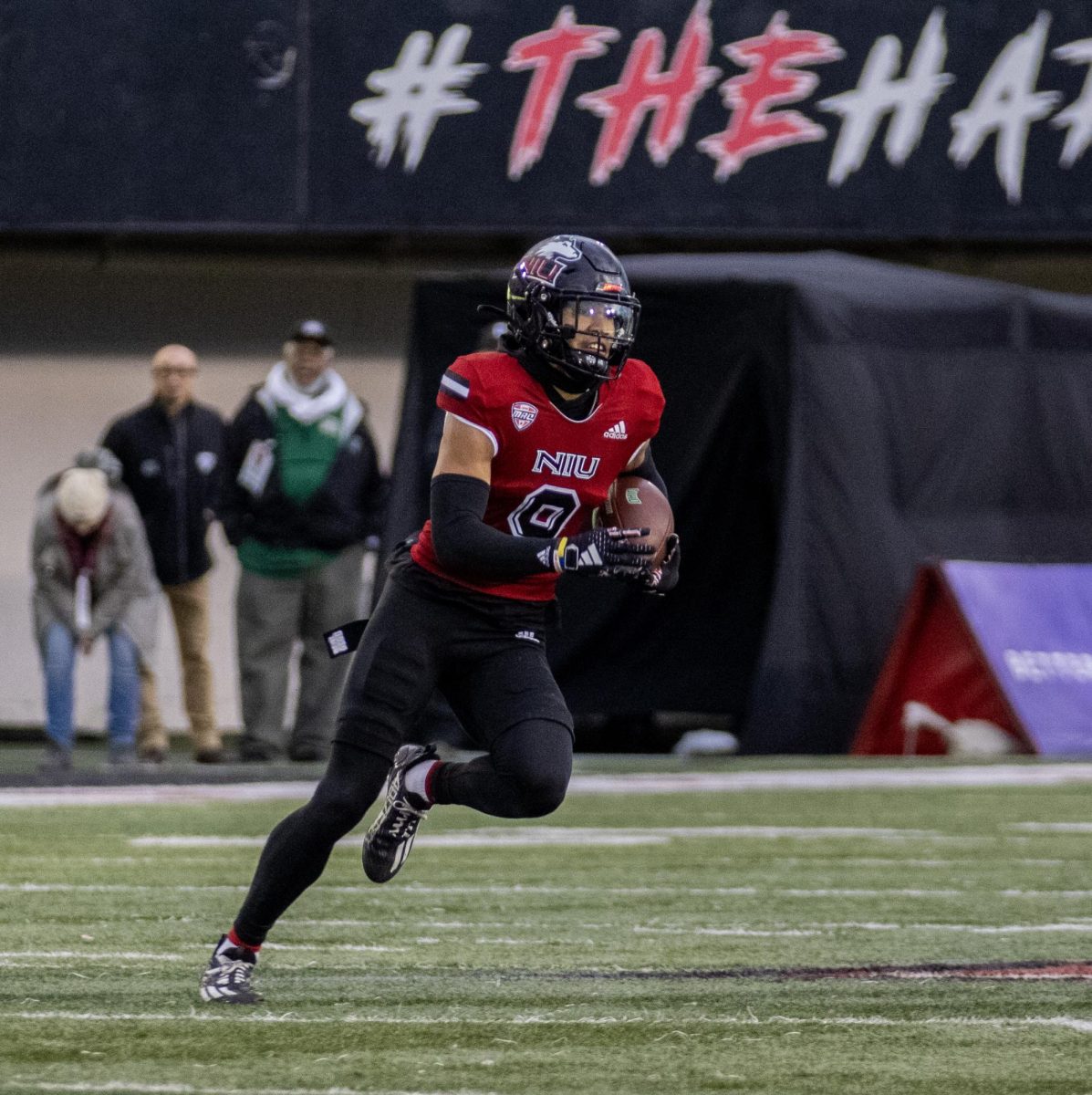 NIU junior safety Nate Valcarcel (9) runs back an interception during the fourth quarter against Ohio. The Huskies won the game 23-13. (Tim Dodge | Northern Star)