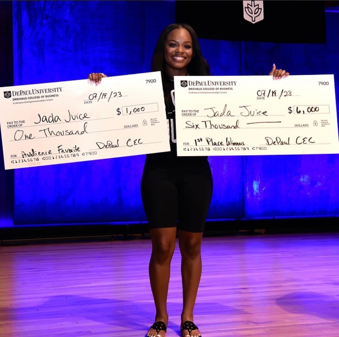 Jada Samuels holds her checks for $7,000 from the University Pitch Madness competition. Samuels is the CEO of Jada Juice, an all-natural smoothie company. (Courtesy of Jada Samuels)