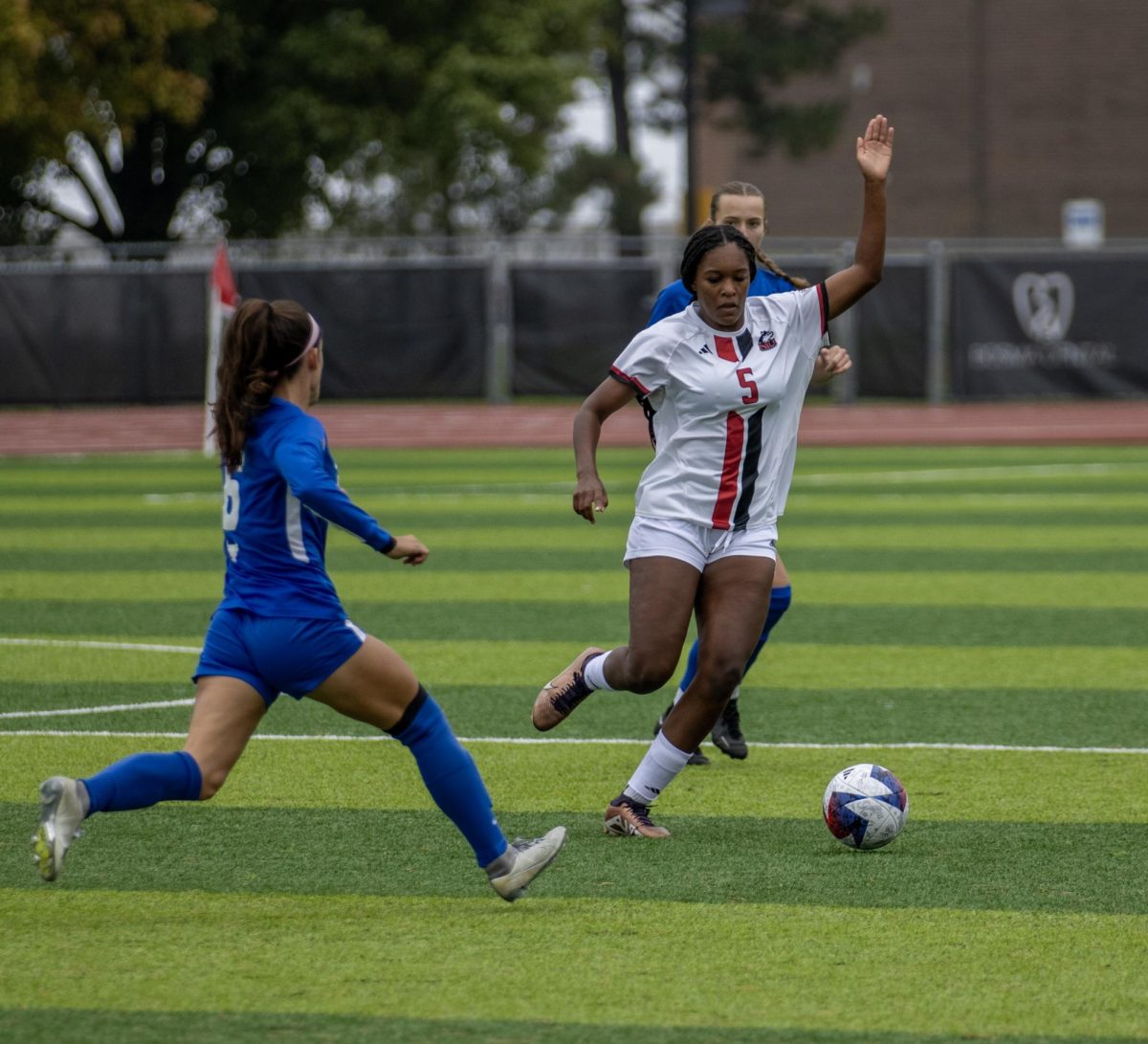 Freshman forward Tyra King dribbles the ball past a University at Buffalo defender. NIU womens soccer defeated Ball State University on Thursday after a last-minute goal from King. (Tim Dodge | Northern Star)