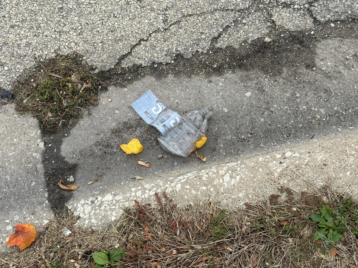 A littered Gatorade bottle lays on the ground near Neptune Hall. Students need to do their part in keeping campus clean. (Olivia Zapf | Northern Star)