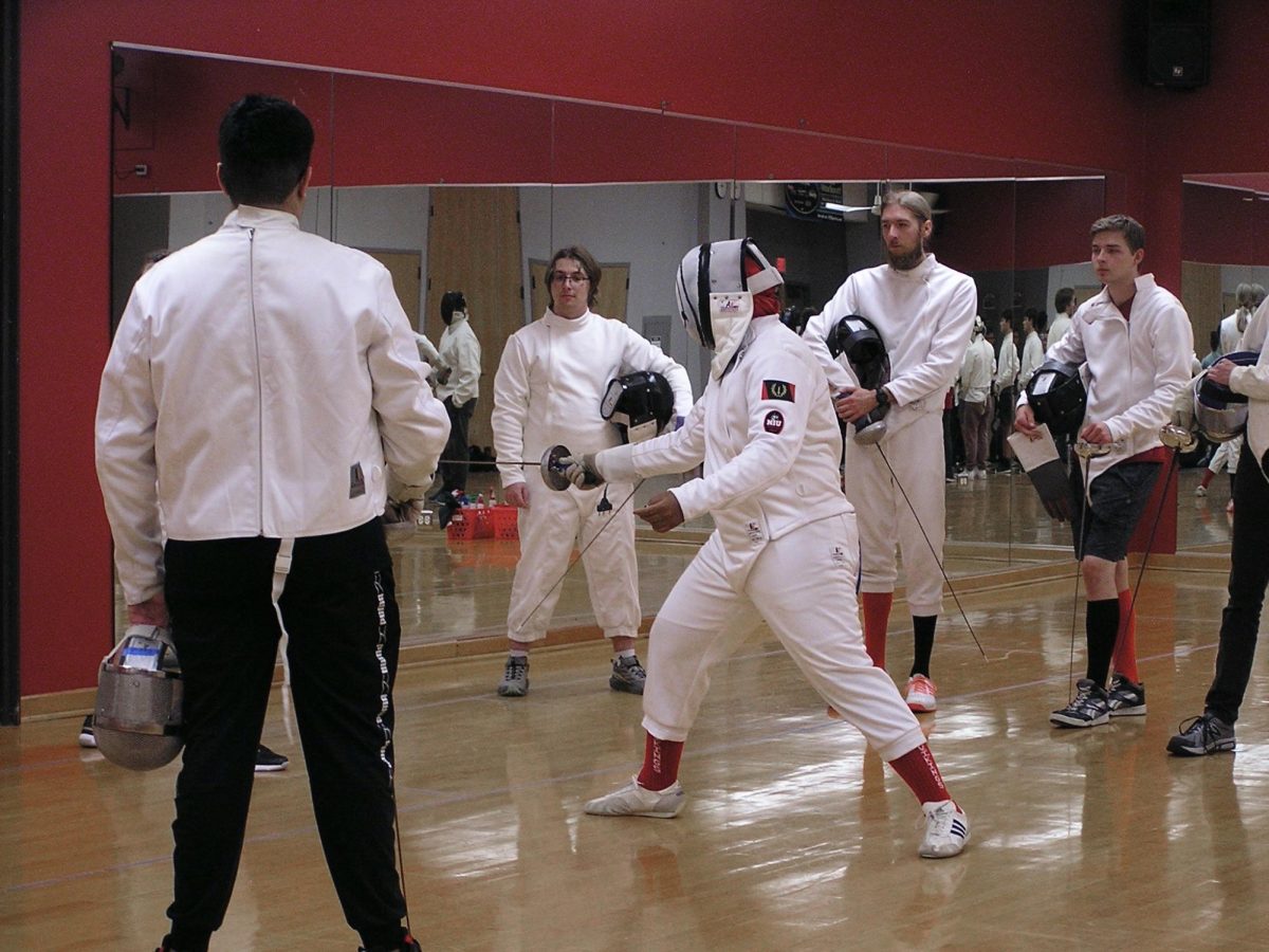 Ethan Gamble, a junior computer science major, demonstrates a practice drill for other members to work on during Fencing Club on Monday night. Gamble has been a part of the club for three years, and he said it’s been a great experience. (Josephine Dunmore | Northern Star)