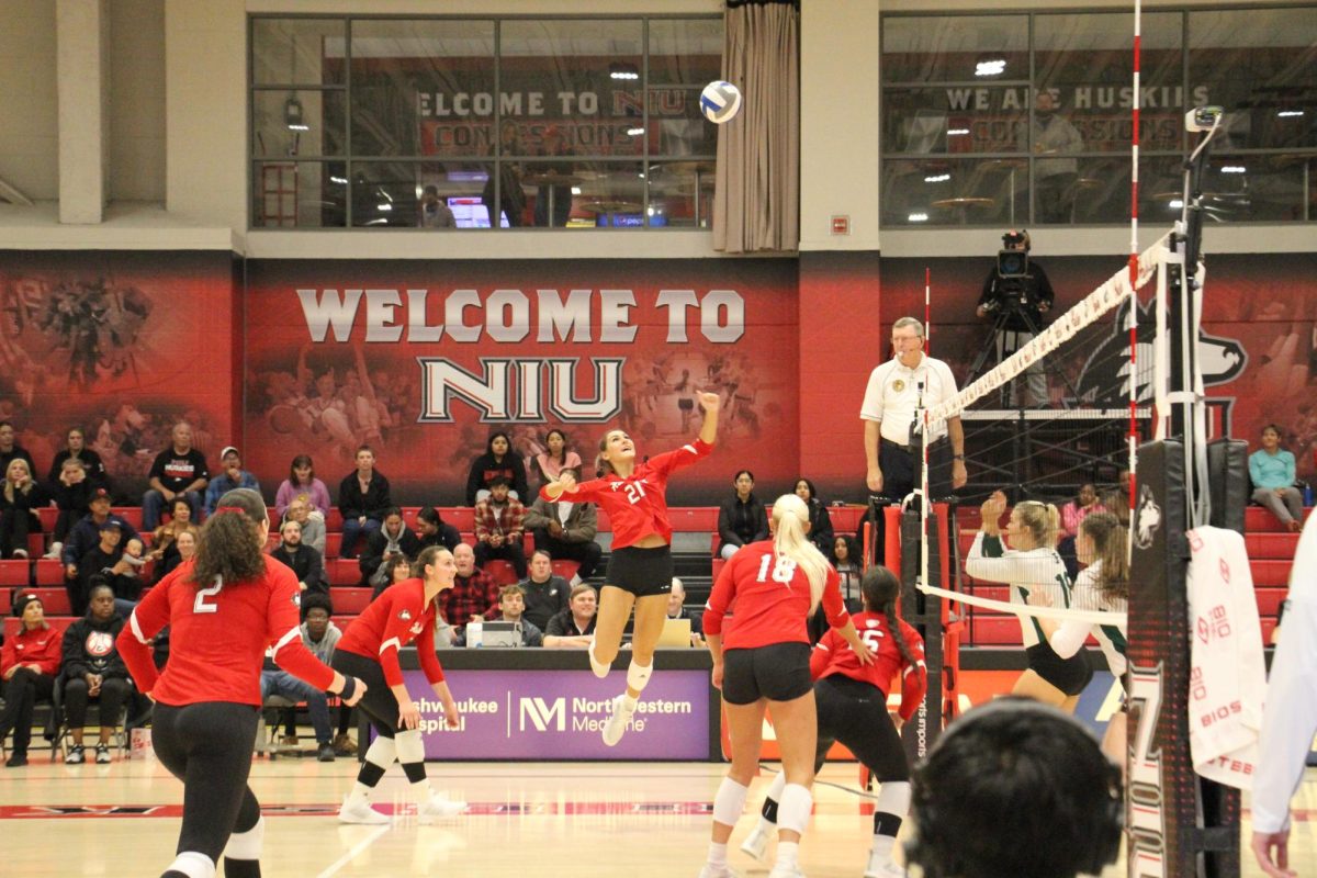 NIU junior outside hitter Nikolette Nedic (21) jumps in the air for an attack against Eastern Michigan University during Thursday’s match at Victor E. Court. The Huskies return to action Tuesday for a matchup with conference powerhouse Western Michigan University in Kalamazoo, Michigan. (Ariyonna McGahee | Northern Star)
