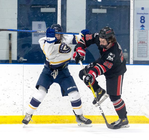 Freshman forward Jeff Shirkey battles for the puck against a Kent State defender on Sept.15. The Huskies have struggled to open the season, losing their first eight games. (Courtesy of NIU Hockey)