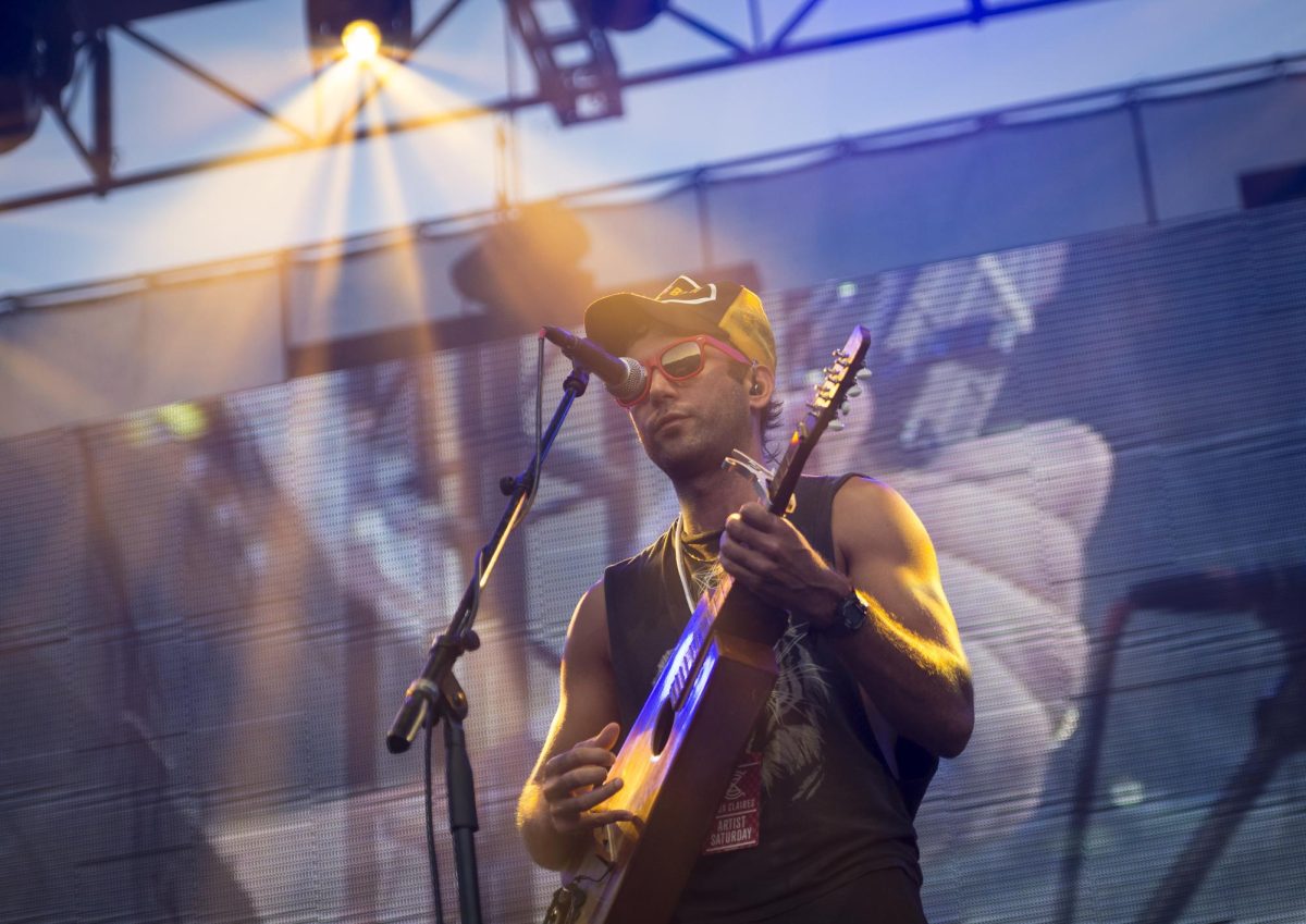 Sufjan Stevens performs at Eaux Claires music festival in red sunglasses. Stevens recently released his album Javelin, dedicating it to his partner who passed away in April. (Aaron Lavinsky/Star Tribune via AP)