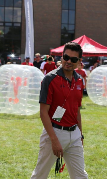 NIU cross country head coach Juan Carrillo takes in the scene at an NIU event. Carrillo is in his first year as head coach of NIU cross country. (Courtesy of NIU Athletics)