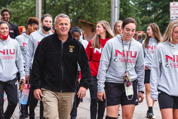 DeKalb Mayor Cohen Barnes walks alongside NIU students. Cohen Barnes announced his election bid for state representative of the 76th House District for 2024 on Sept. 22. (Northern Star File Photo)
