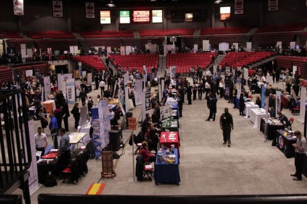 Employers set up tables on the floor of the Convocation Center for a job fair. The All-Majors Internship and Job Fair takes place at the Convocation Center on Wednesday. (Northern Star File Photo)