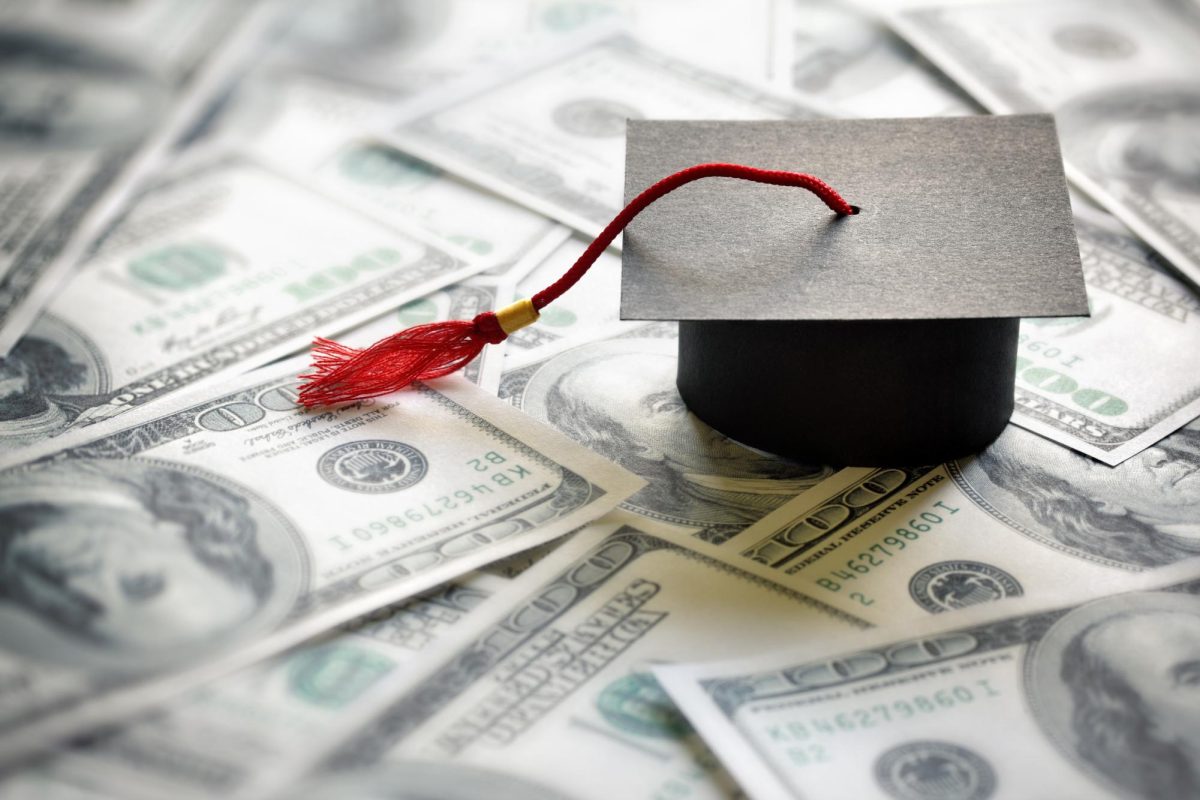 Graduation cap sits on $100 bills. The U.S. Department of Education withheld over $7 million to the Missouri Higher Education Loan Authority for sending late billing statements to over 800,000 borrowers. (Getty Image) 