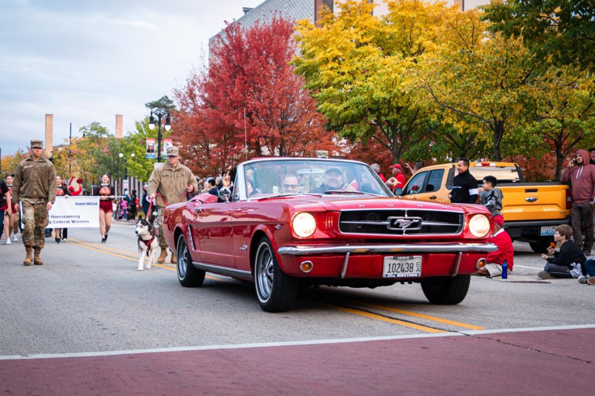 A classic Mustang drives down a road taking part in the 2022 homecoming parade. Homecoming will include events hosted by the university as well as local businesses. (Northern Star File Photo)