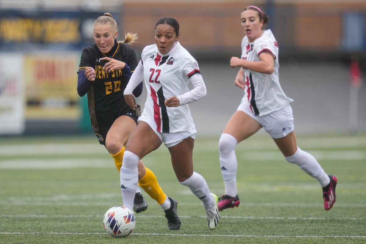 Graduate student forward Sahara Zingano dribbles the ball past Kent State University defenders. The Huskies were defeated by the Golden Flashes in the quarterfinals of the MAC Tournament on Sunday. (Courtesy NIU Athletics)