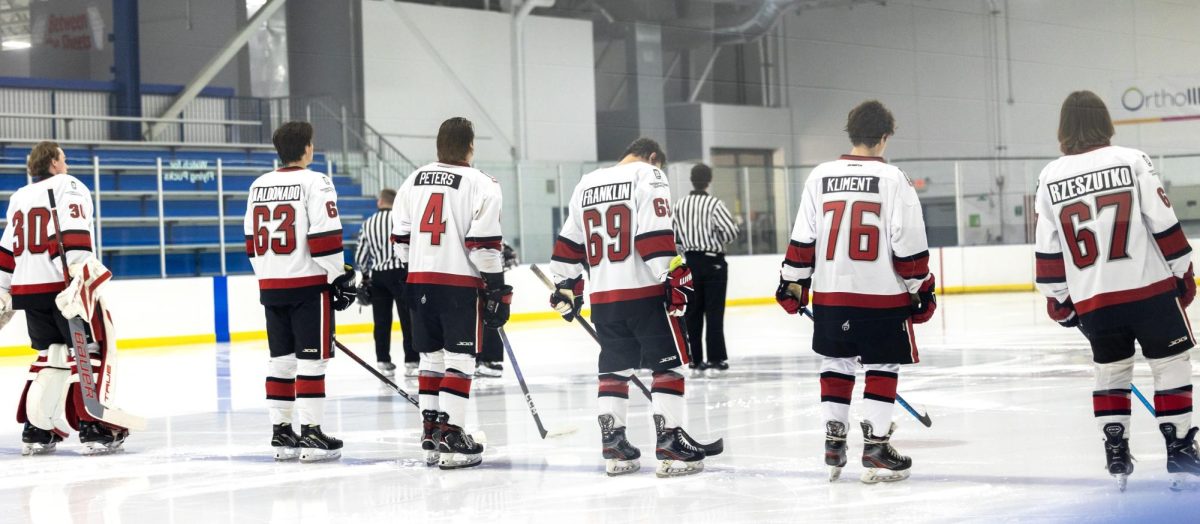NIU Hockeys starting lineup stands on the blue during the national anthem before Fridays game against the University of Jamestown. The Huskies fell to Jamestown by a final score of 13-0 on Saturday. (Courtesy of NIU Hockey)