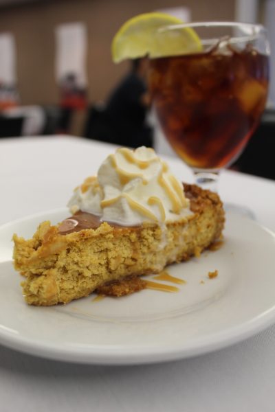 A homemade pumpkin cheese caked and whipped cream served with a side of iced tea and lemon. This dessert was served at Ellingtons Restaurant located inside the Holmes Student Center. (Sasha Norman | Northern Star)