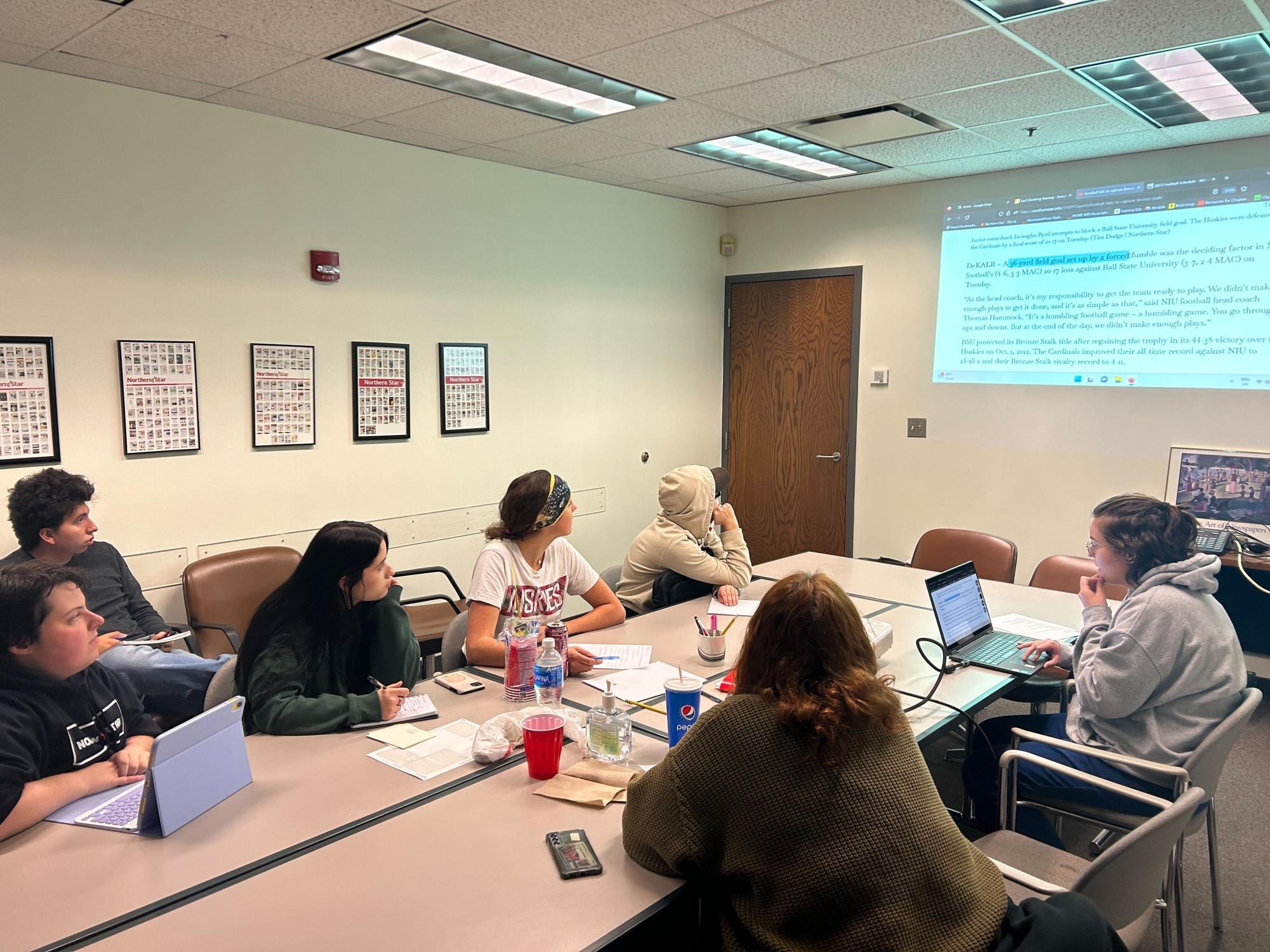 A group of Northern Star staffers sit around a table. The Northern Star Editorial Board outlines the basics of news literacy. (Joey Trella | Northern Star) 