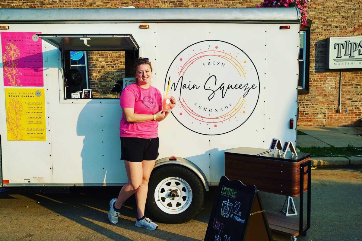 Madison Wescott holds an energy drink in front of her food truck, Main Squeeze. Wescott sells homemade lemonade and energy drinks to pay for her college tuition. (Courtesy of Madison Wescott)