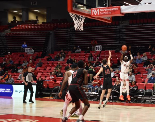 Freshman guard Will Lovings-Watts shoots a three pointer against the Illinois Institute of Technology. NIU mens basketball trounced Illinois Tech by a final score of 107-55. (Joey Trella | Northern Star)