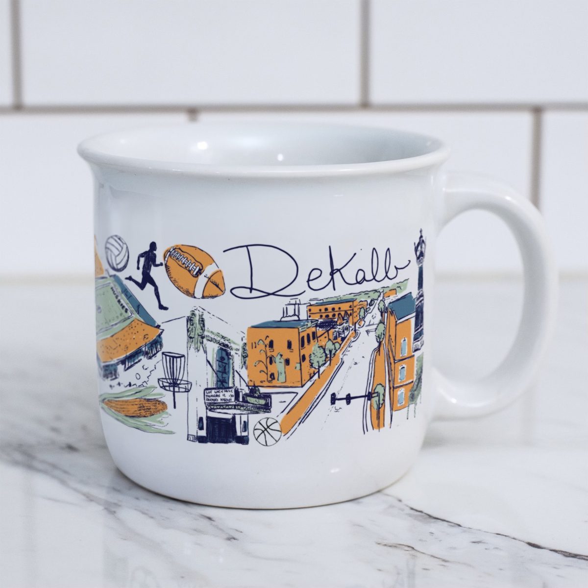 A mug sits on a marble counter. Ashley Klockenga, an NIU alum, has created a mug that embodies the spirit of DeKalb. (Courtesy of Ashley Klockenga)