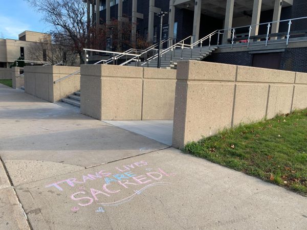 “Trans lives are sacred!” is written in sidewalk chalk in front of the Jack Arends Hall. The Transgender Day of Rememberance is a yearly observance on Nov. 20 for individuals who’ve lose their lives to anti-transgender violence. (Rachel Cormier | Northern Star)