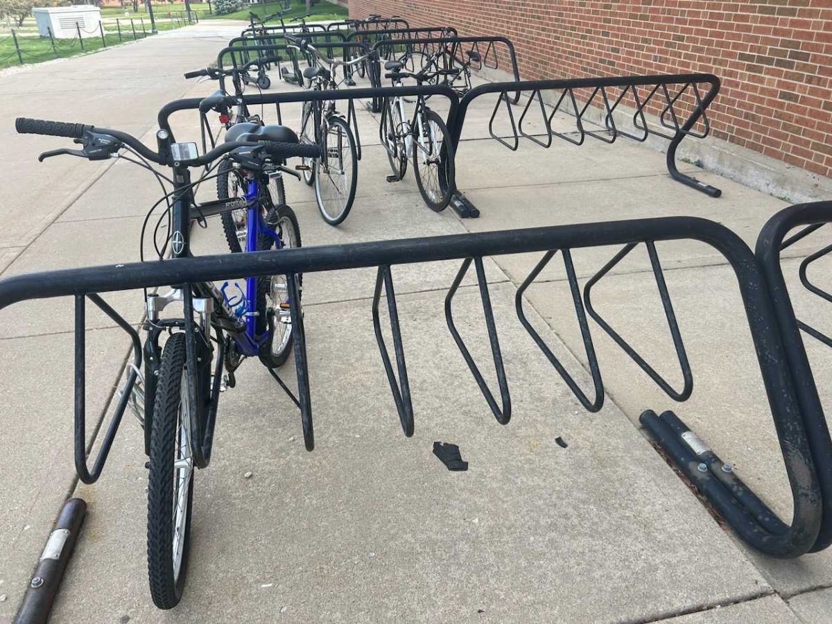 Bikes sit tied to a bike rack outside of DuSable Hall on a foggy morning. NIU students are traveling around campus in different forms of personal transportation. (Cameron Whittington | Northern Star)
