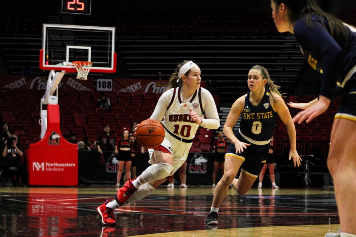 Fifth year guard Chelby Koker (10) advances the ball down court past Kent State University junior guard Casey Santoro (0) on Jan. 25.  Koker racked up 21 points throughout the game at the NIU Convocation Center. (Nyla Owens | Northern Star)