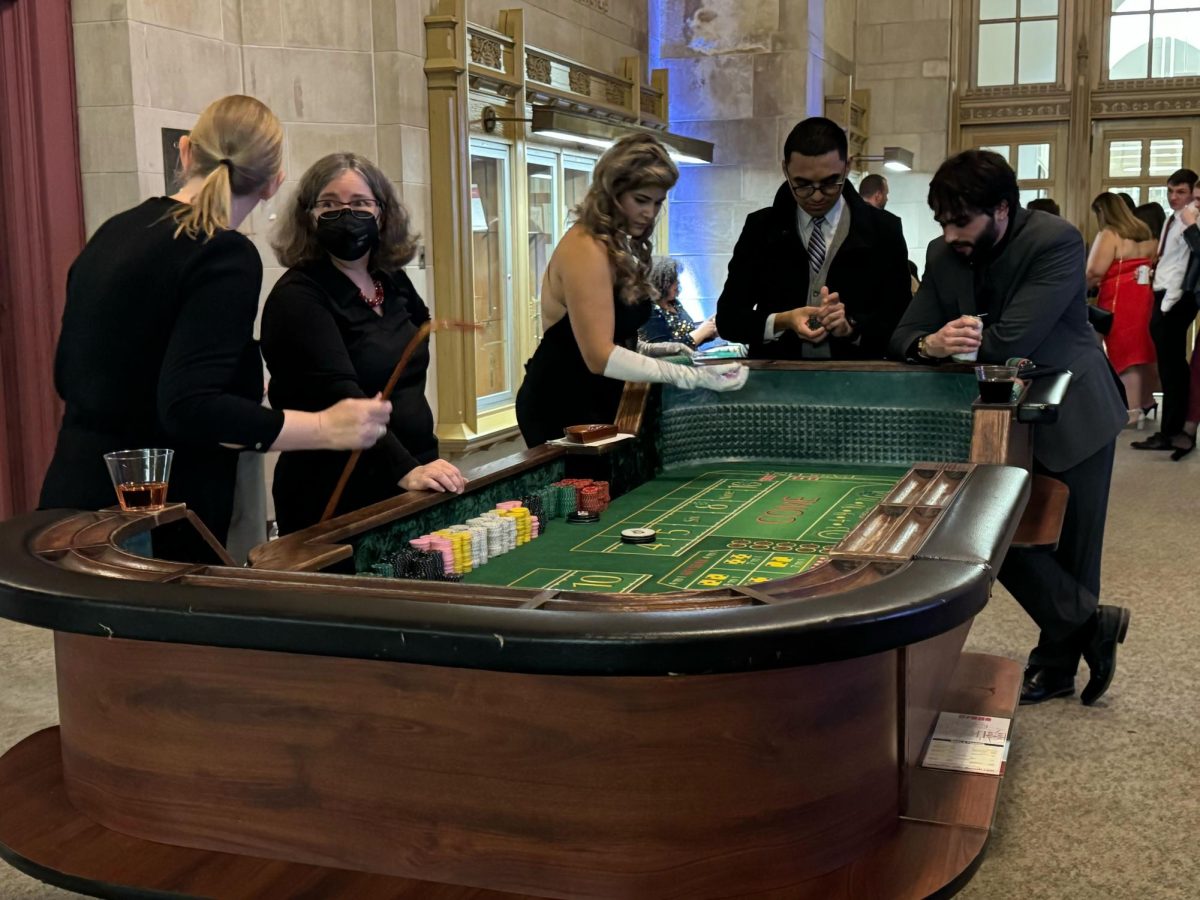 NIU law students partake in a game of craps. The SBA hosted a Casino Night at the Marshall Gallery in Swen Parson Hall. (Gabby Crabtree | Northern Star)