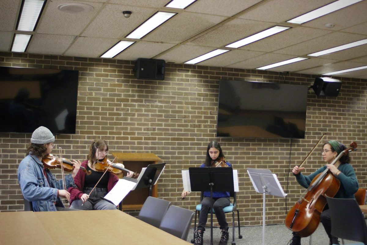 Violinists Riley Farrell (left) and Jordan Weiss ,violist Elianna Nielsen and cellist Hannah Sheridan are a part of the Ravel Quartet. They performed at the Founders Memorial Library Thursday, playing pieces by Maurice Ravel. (Josephine Dunmore | Northern Star)