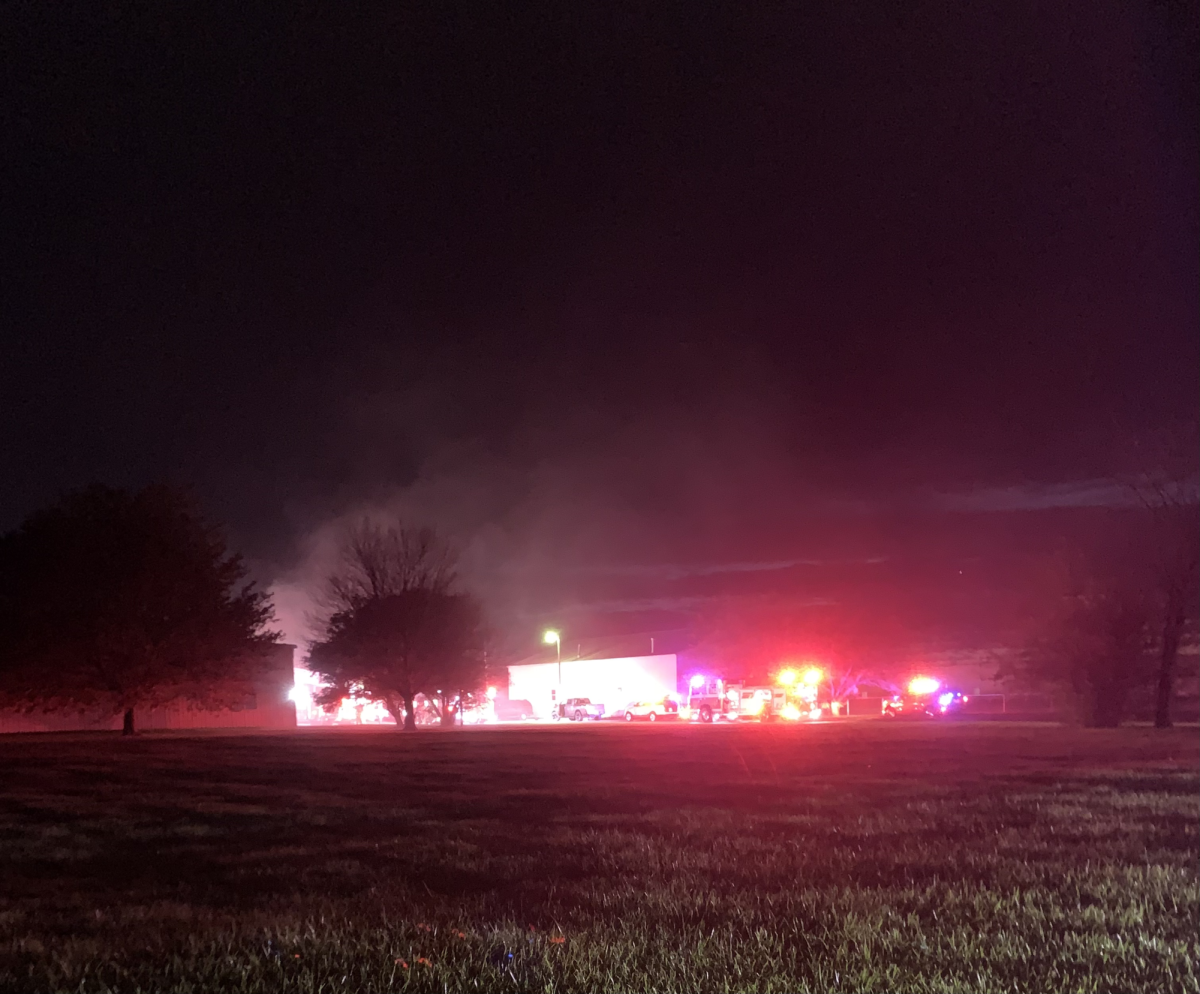 Emergency vehicles flash their lights. A structure fire occurred at 2120 Pleasant Street. (Nick Glover | Northern Star)