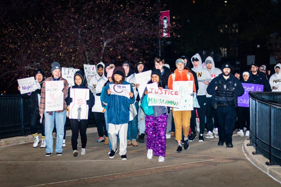 (From left) NIU students Maggie Van Heemst, Raeleen Trovelq, Angel Cabang and Susan Johnson leading the Take Back the Night march across campus. Everyone deserves to feel safe at night and during the day. (Mingda Wu | Northern Star)