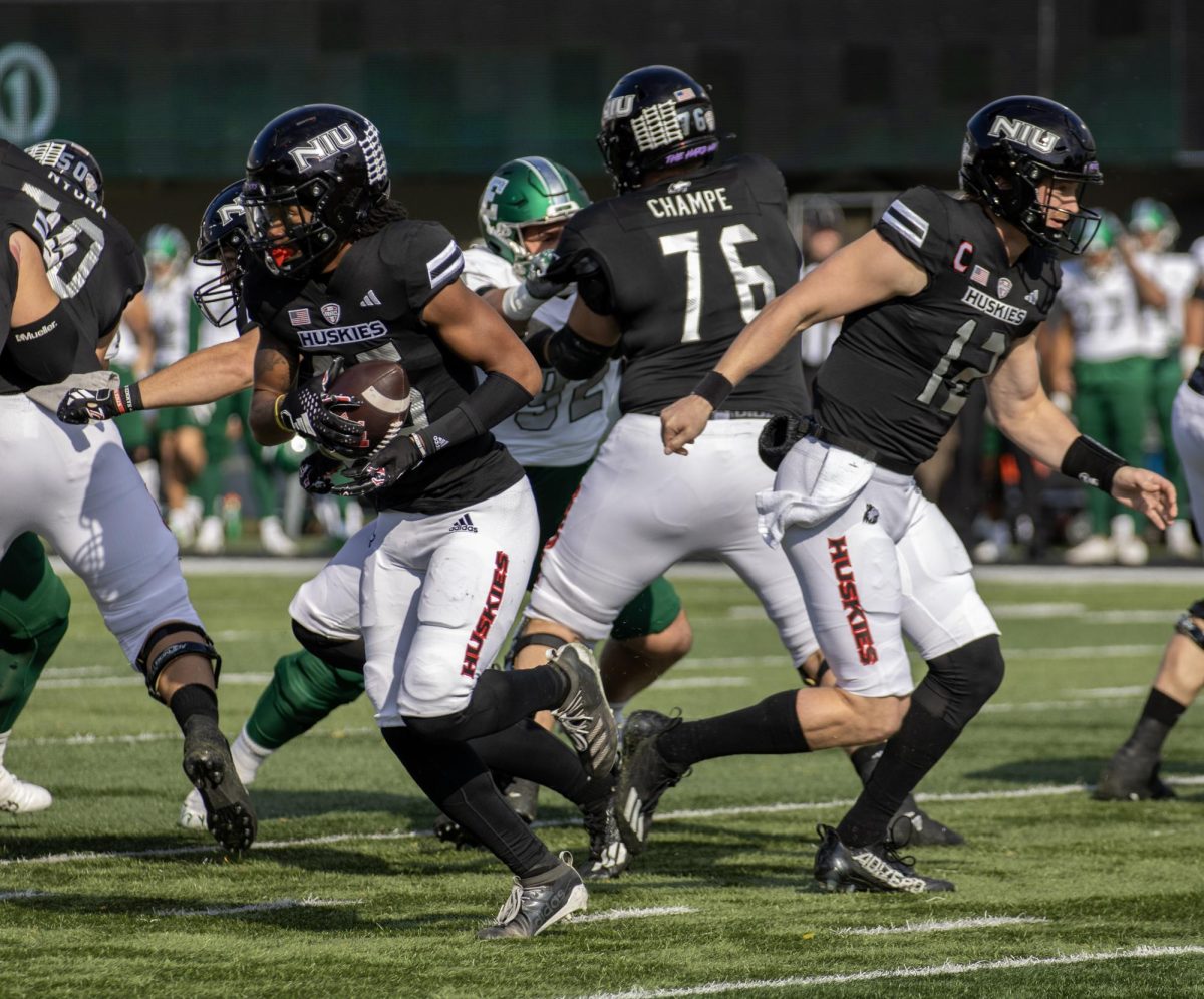 Redshirt junior wide receiver Trayvon Rudolph receives a handoff during NIU footballs game against Eastern Michigan University on Oct. 22. The Huskies comeback bid fell short in a 37-31 loss to Central Michigan on Tuesday. (Tim Dodge | Northern Star)