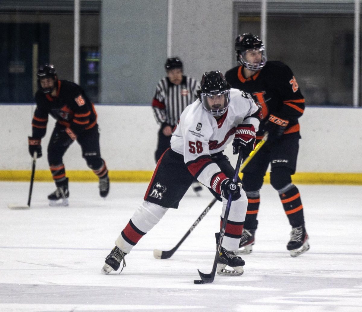 Freshman defenseman Ethan Koval rushes the puck through the neutral zone in NIU Hockeys game on Oct. 13. The Huskies will face Alabama, Rhode Island and Arizona State in the ACHA Showcase this weekend. (Courtesy of NIU Hockey)