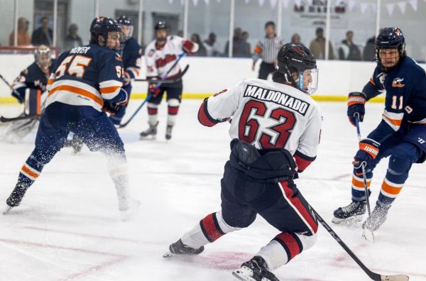 Freshman forward Micah Maldonado does a hockey stop while battling for the puck on Oct. 28 against Midland University. The Huskies dropped their third game of the ACHA Showcase 10-2 against Arizona State University on Sunday. (Courtesy of NIU Hockey)