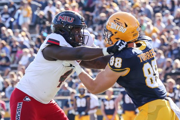 Junior defensive end Ray Thomas rushes the Toledo offensive line in NIU footballs game against Toledo on Sept. 30. Thomas received the MAC West defensive Player of the Week award for his 10 tackles against Kent State on Saturday. (Scott Grau | Kent State Athletics)
