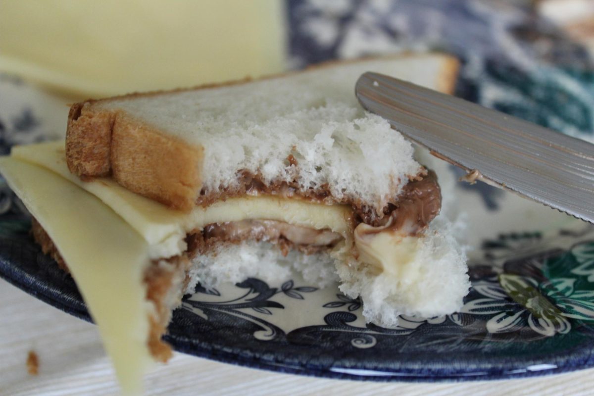 A Nutella and cheese sandwich lays on a blue and white plate. Individuals either embrace or turn away from weird food combinations. (Courtesy of Getty Images) 
