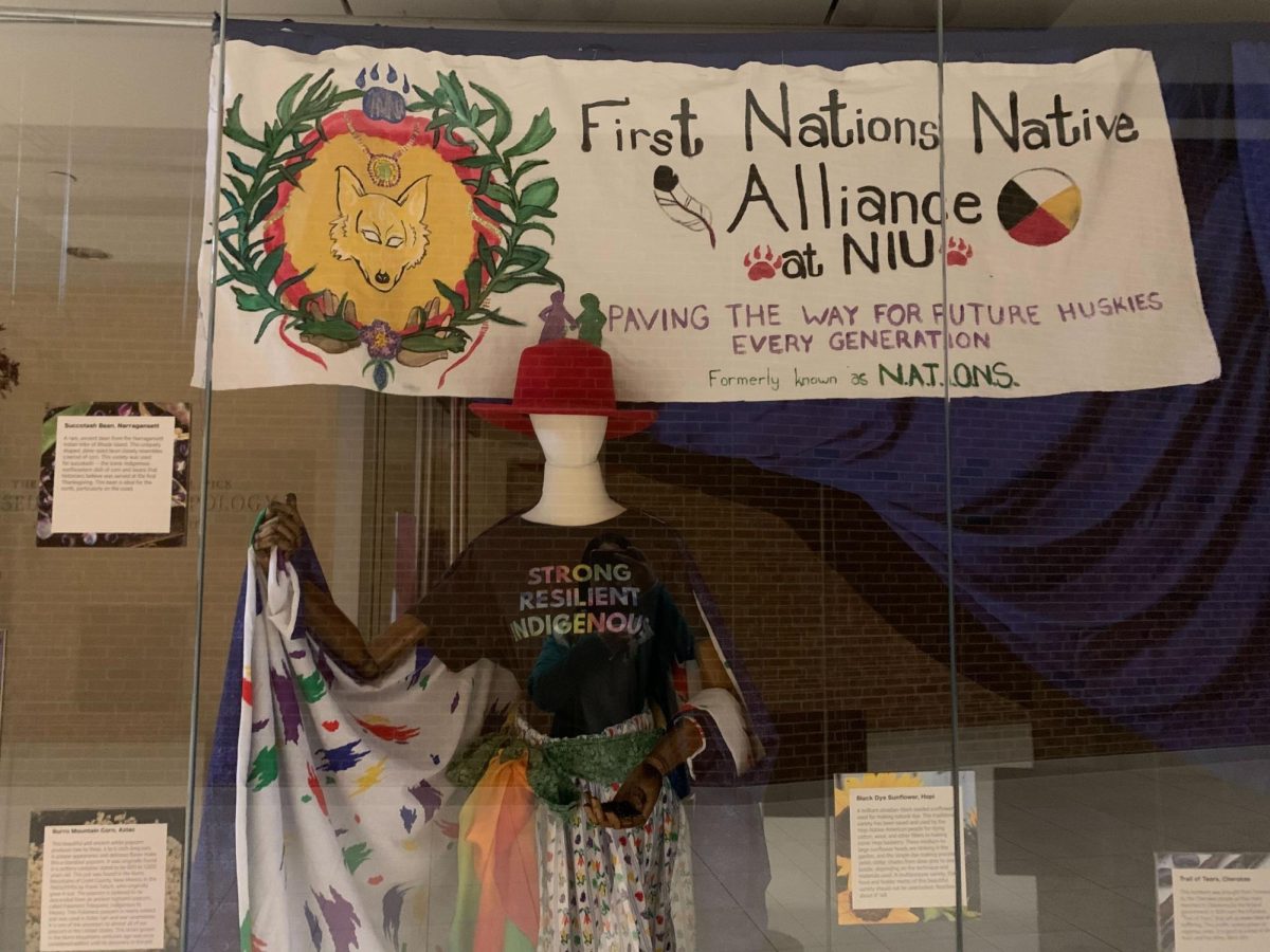 A+display+case+with+a+mannequin+and+banner+from+First+Nations+Native+Alliance+displays+Native+agriculture+and+food+from+the+%E2%80%9CGood+Food%E2%80%9D+exhibit+in+Cole+Hall.+NIU%E2%80%99s+Land+Acknowledgement+recognizes+the+original+Indigenous+populations+that+inhabited+the+land+NIU+stands+on.+%28Rachel+Cormier+%7C+Northern+Star%29+