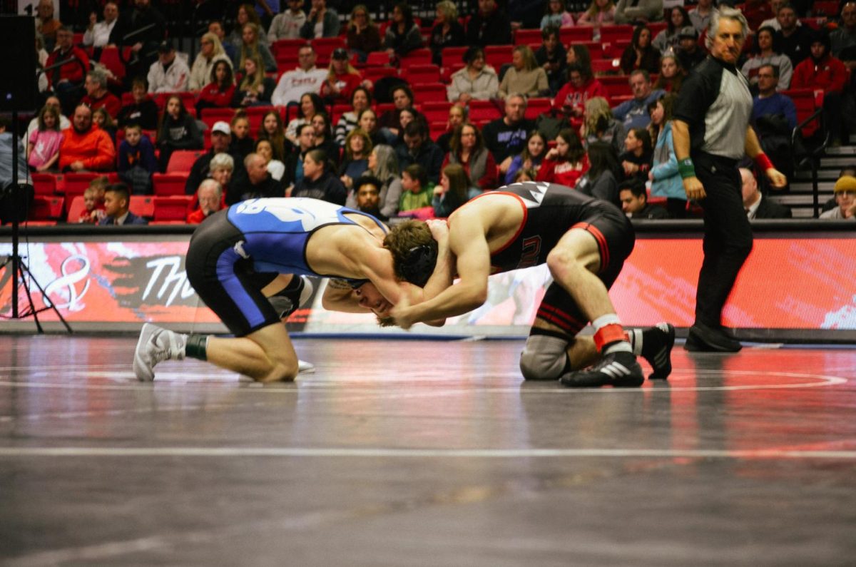 Then-redshirt freshman Blake West opposes Buffalo’s then-redshirt freshman Mason Bush in NIU wrestlings match against Buffalo on Feb. 4. West earned third place at 125 pounds in the Cougar Clash on Saturday. (Northern Star File Photo)