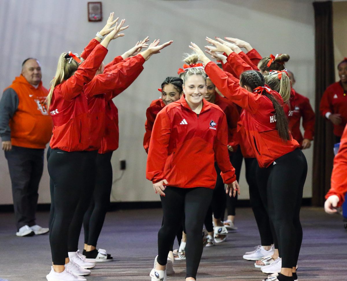 Senior Olivia Lynd and the rest of the Huskie gymnasts make their entrance to a Jan. 13 meet against Bowling Green State University in Bowling Green, Ohio. NIU gymnastics is set to compete in a tri-meet against Central Michigan University and Eastern Michigan University on Sunday. (Courtesy of Dena Martz)