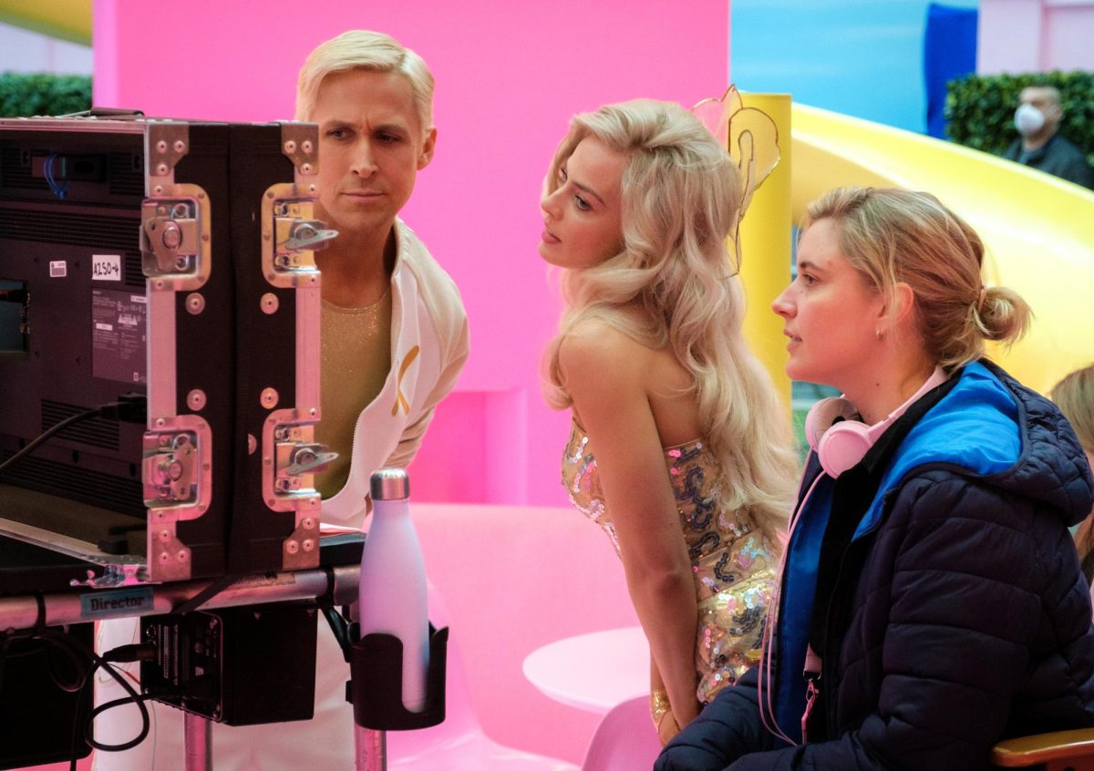 Ryan Gosling (from left), Margot Robbie and Greta Gerwig look at a screen on the set of Barbie. Gosling has been receiving far more praise for his performance as Ken in the film, where Robbie and Gerwig are receiving less praise. (Jaap Buitendijk | Warner Bros. Pictures via AP)