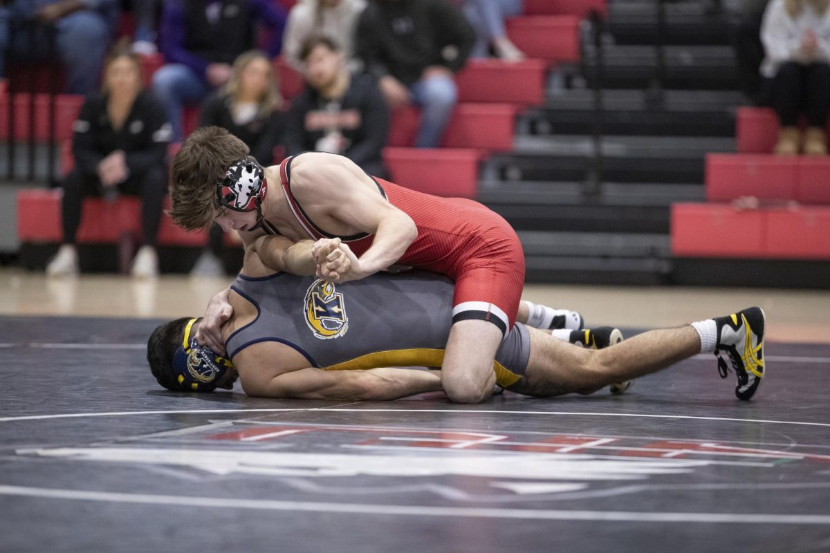 Redshirt sophomore Blake West pins his Kent State University opponent on Dec. 19. West recorded his 20th victory of the 2023-2024 season on Saturday against Cleveland State University. (Scott Walstrom | Courtesy of NIU Athletics)