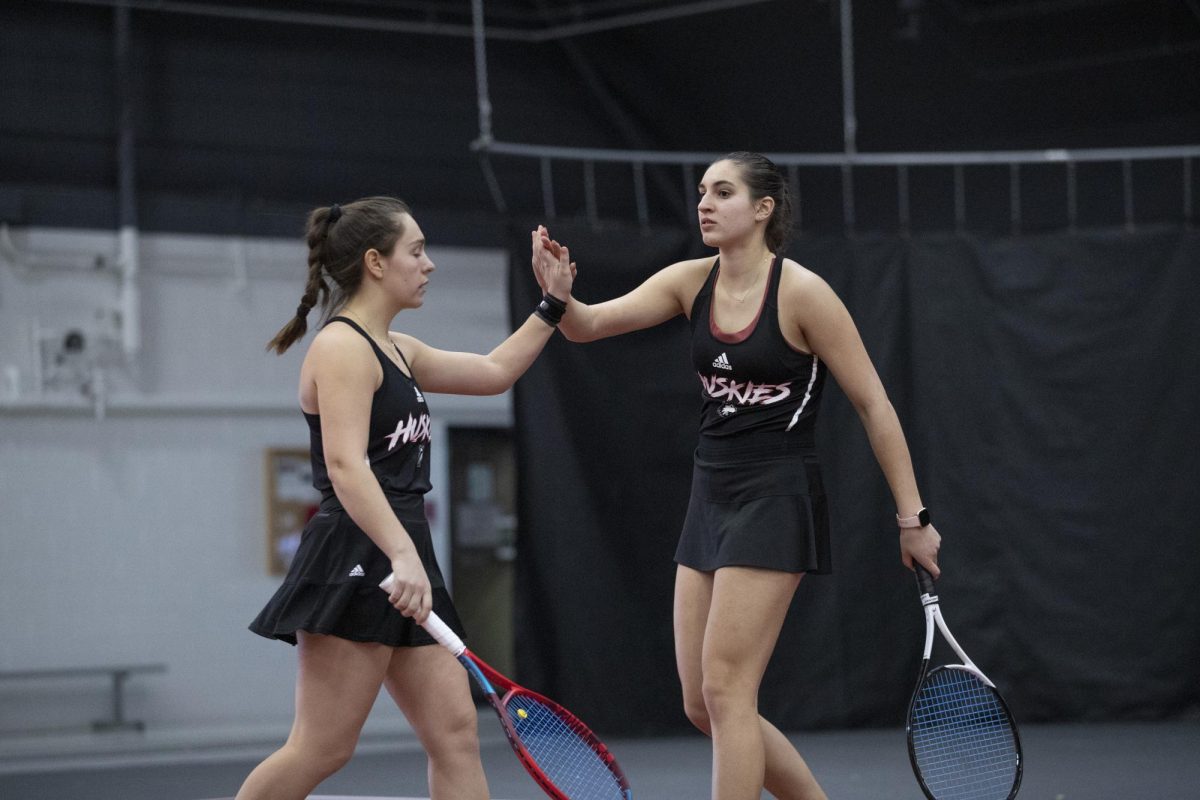 Sophomore Nataly Ninova (left) and junior Erika Dimitriev celebrate a point during an NIU womens tennis home match against the University of Wisconsin on Saturday. (Courtesy of NIU Athletics)