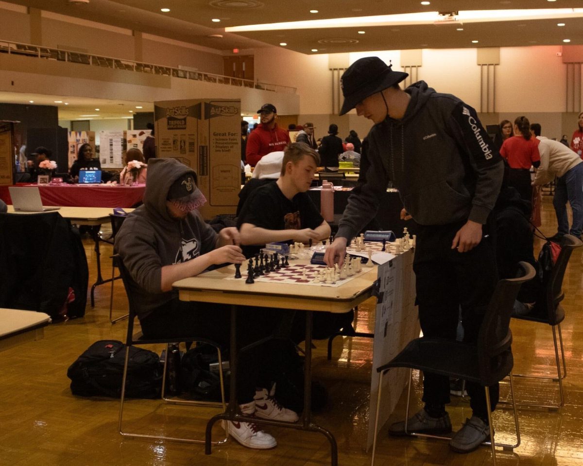 Senior biochemistry major Konur Kivisto (left), freshman computer science major Jakob Kasarcik and sophomore finance major Ryan Kramer play chess Tuesday at the Spring Involvement Fair. The fair was the first of many events happening at NIU this semester. (Sean Reed | Northern Star)
