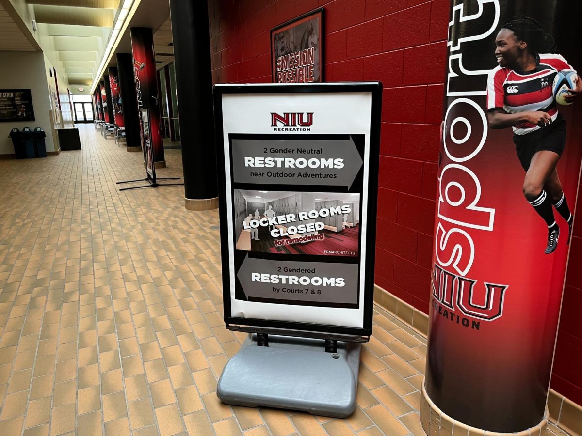 A board sits outside NIU’s Recreation Center locker rooms stating they are closed for remodel. The Recreation Center locker rooms are receiving $1.37 million renovation. (Sarah Rose | Northern Star)