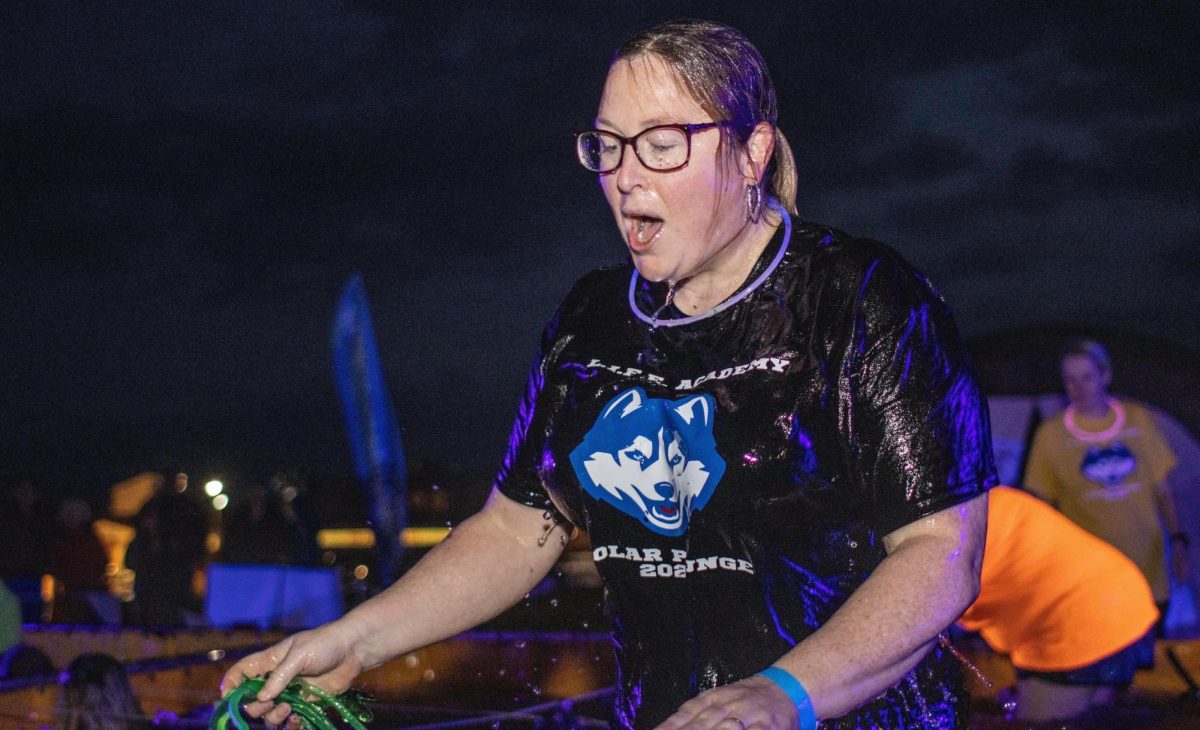 A participant in a Polar Plunge stands soaked in water. At 10 a.m. on Feb 17 at Huskie Stadium, the Special Olympics are hosting a Polar Plunge event where people will dive into a pool of water. (Courtesy of Special Olympics)