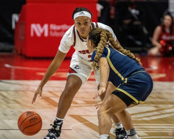 Senior guard Jayden Marable (3) attempts to create space and drive past Akron junior guard Kaia Woods (0). The Huskies and Akron are scheduled to face off again March. 2 in Ohio. (Tim Dodge | Northern Star) 