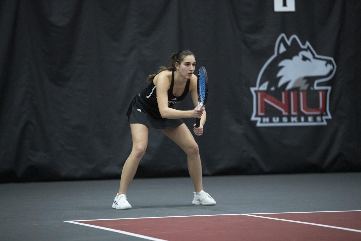 Junior Erika Dimitriev prepares for her opponents serve in a home meet against the University of Wisconsin-Madison on Saturday. Dimitriev won her lone single match against James Madison on Sunday. (Courtesy of NIU Athletics)