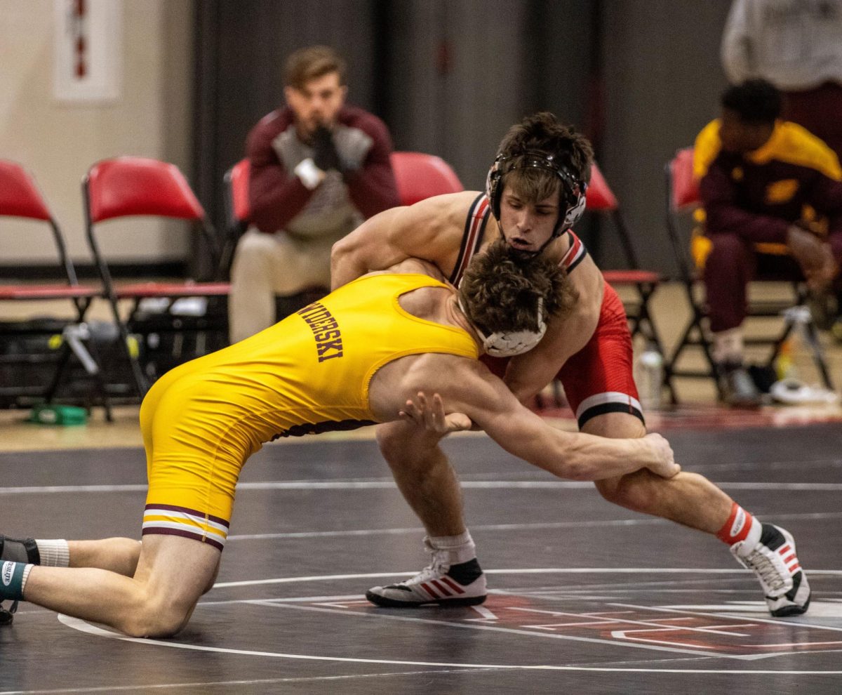 Redshirt freshman Tommy Bennett holds off Central Michigan University redshirt sophomore Tyler Swiderski in a dual against the Chippewas on Saturday. Bennett defeated Swiderski 5-4 in a decision victory. (Tim Dodge | Northern Star)