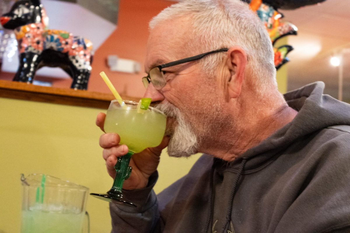 Sycamore resident Steve Holliday takes his first sip of his margarita from Rosita’s, located at 642 E. Lincoln Highway. Rosita’s sells Mexican food along with a selection of alcoholic beverages. (Gabby Crabtree | Northern Star)