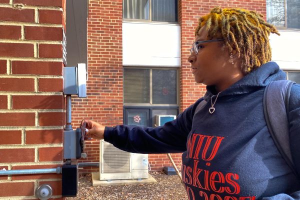 Ke’ra Craig, a first-year theology major, taps her One Card on the card reader to unlock a door to Neptune Hall. On Wednesday, NIU had a software issue causing One Card readers to temporarily stop working. (Sean Reed | Northern Star)
