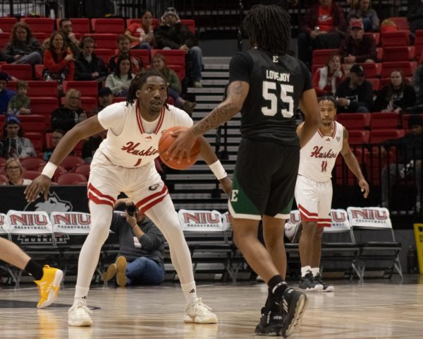 Freshman guard Will Lovings-Watts (1) gets in stance to guard Eastern Michigan University sophomore guard Orlando Lovejoy (55). Lovings-Watts scored 18 points and swiped 5 steals in NIU mens basketballs victory over the Eagles on Saturday. (Sean Reed | Northern Star)