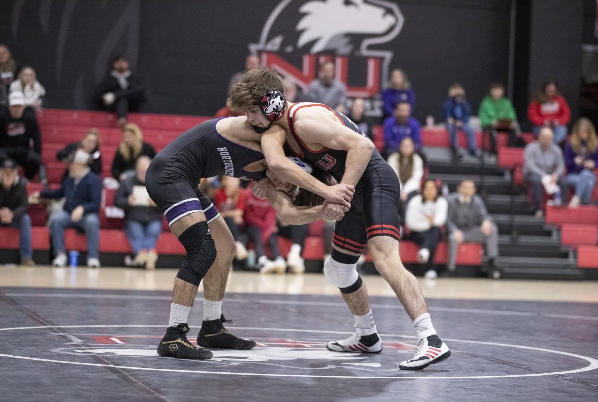 Sophomore Blake West grapples a Northwestern University wrestler at the Convocation Center on Dec. 19 2023. West won his match on Saturday against the University at Buffalo by technical fall, making him 6-0 in MAC play this season. (Courtesy of NIU Athletics)